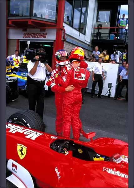 Formula One World Championship: Second place Rubens Barrichello, left, congratulates Ferrari team mate Michael Schumacher, right, on his record