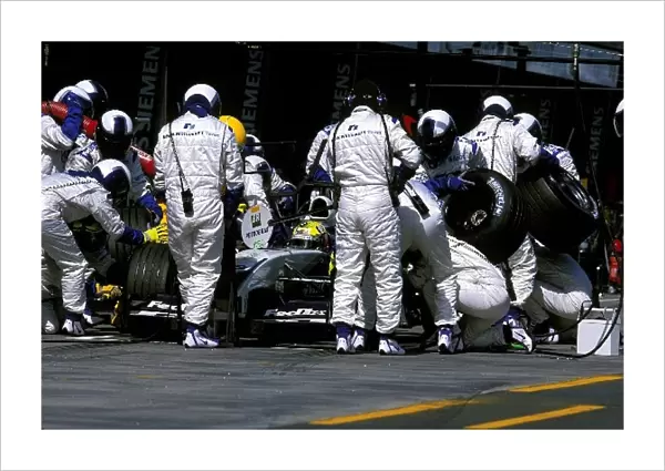Formula One World Championship: Ralf Schumacher, BMW Williams FW24, takes a regular pit stop but was slowed when the mechanic had problems changing