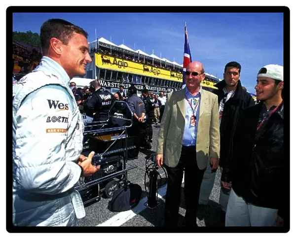 Formula One World Championship: Saudi Prince, Khaled Al Waleed, right, and his representative Brendan McGuiness, centre, meet David Coulthard