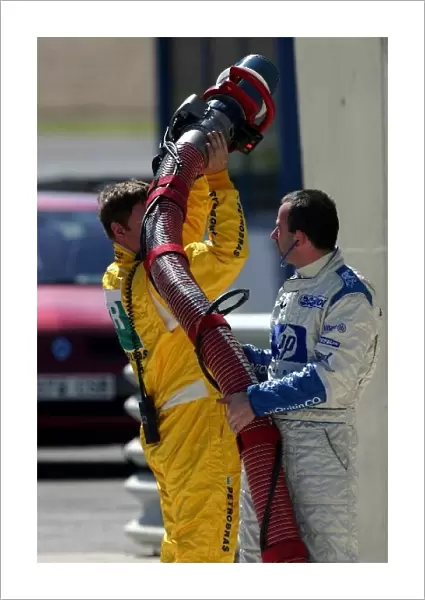 Formula One Testing: BMW Williams mechanics empty a refuelling hose