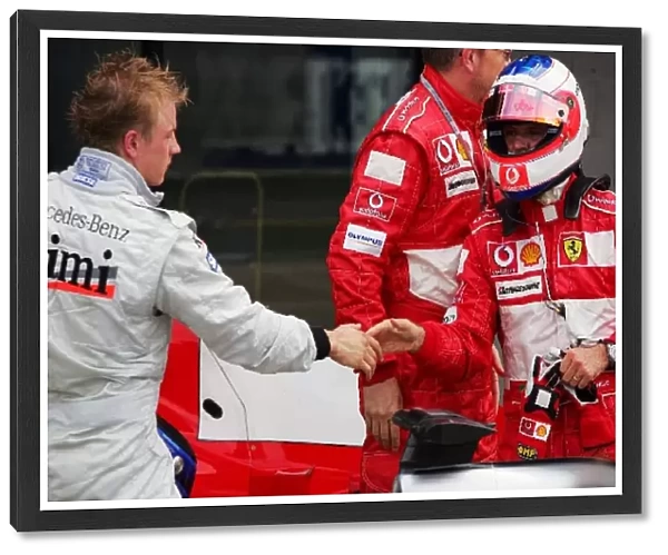 Formula One World Championship: second placed Kimi Raikkonen McLaren congratulates Rubens Barrichello Ferrari
