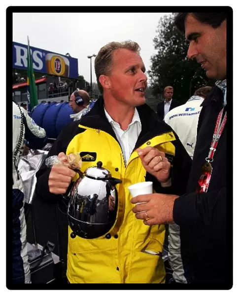 Formula One World Championship: Johnny Herbert Jordan Sporting Relations Manager on the grid with a pot of tea