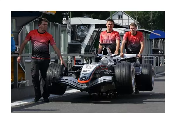 Formula One World Championship: Car of Juan Pablo Montoya McLaren Mercedes MP4  /  20 is pushed down the pitlane to scrutineering