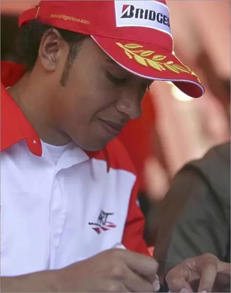 2006 GP2 Series. Round 3. Nurburgring, Germany. 5th May 2006. Friday practice. Lewis Hamilton (GBR, ART Grand Prix) signs autographs. Portrait. World Copyright: Andrew Ferraro / GP2 Series Media Service. Ref: Digital Image Only.ZP9O9636.jpg