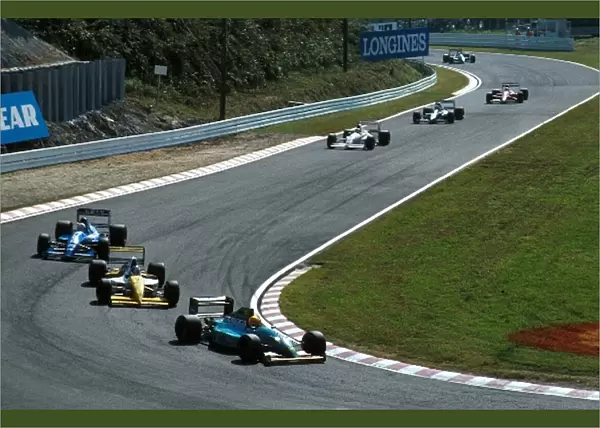 Formula One World Championship: Mauricio Gugelmin in the Leyton House holds up a queue of cars