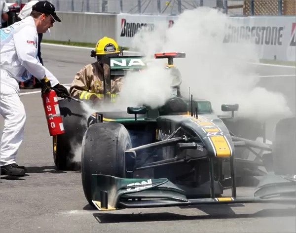 Formula One World Championship: Jarno Trulli Lotus T127 retires in the pitlane