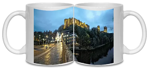 Pedestrians Walking On A Walkway Over A River At Dusk With Durham Cathedral And Castle On A Hilltop; Durham, England