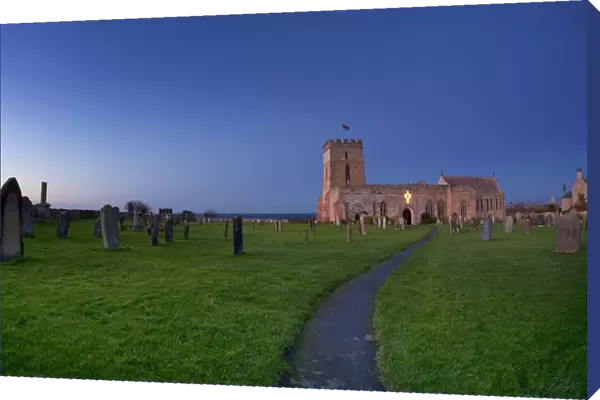 A Path Leading Through A Cemetery To A Church Building; Bamburgh Northumberland England