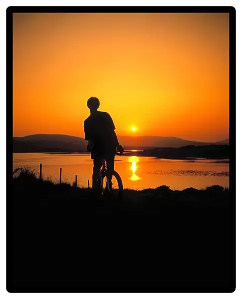 Achill Island, Co Mayo, Ireland; Silhouetted Man On A Mountain Bike