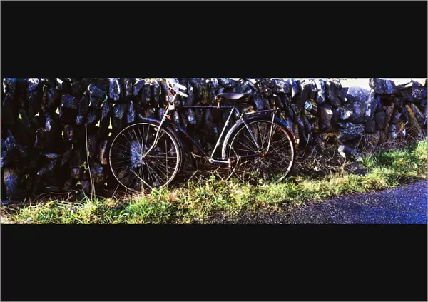 The Burren, County Clare, Ireland; Bicycle Leaning Against Stone Wall