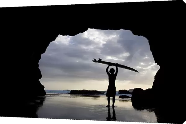 Surfer Inside A Cave At Muriwai North Island New Zealand