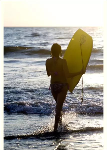Woman On Beach Carrying Bodyboard; Puerto Vallarta, Mexico
