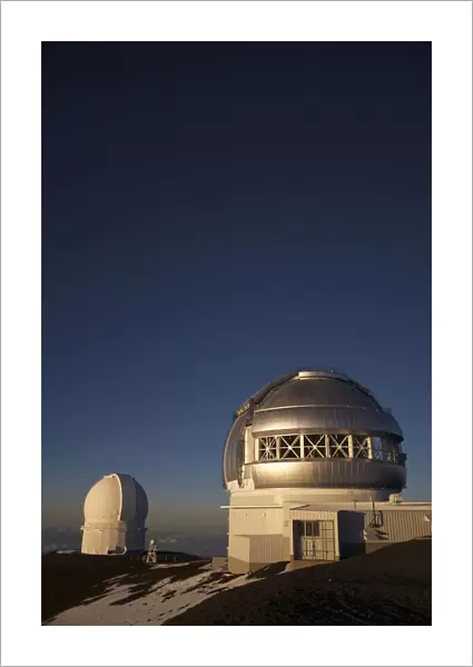 The Sun Sets Over The Summit Of Mauna Kea And The Domed Observatories And Telescopes; Island Of Hawaii, Hawaii, United States Of America
