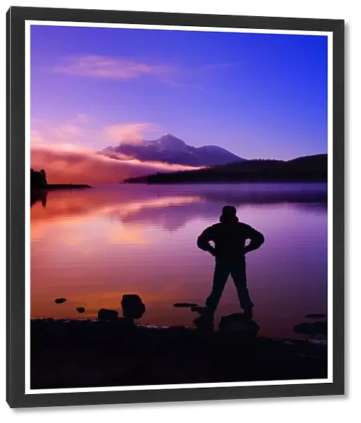 Silhouette Of A Man At A Mountain Lake