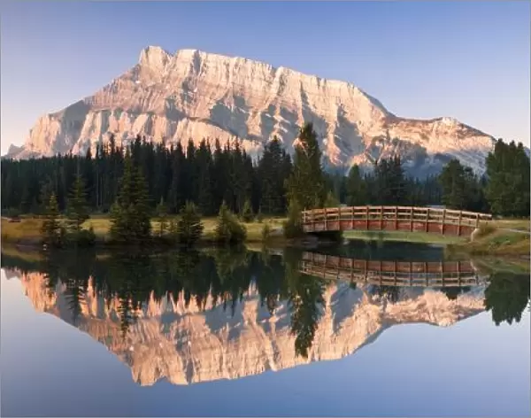 A Scenic Shot Of A Mountainside And Small Bridge; Banff National Park, Alberta, Canada