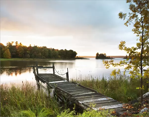 A Dock On A Lake At Sunrise Near Wawa; Ontario, Canada