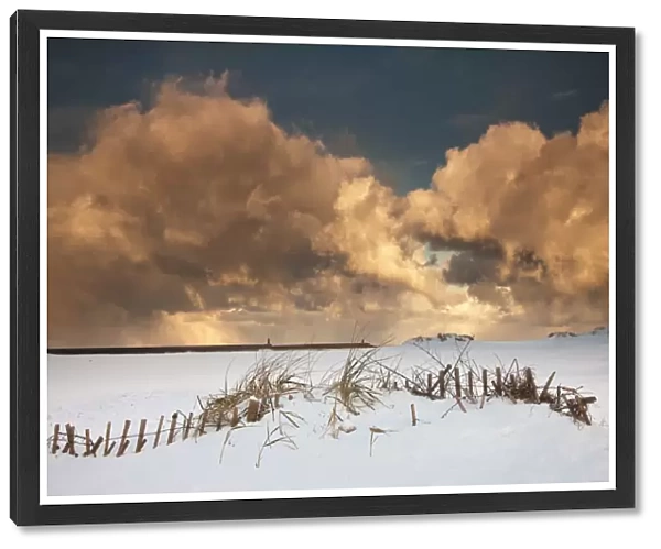 Illuminated Clouds Glowing Above A Snowy Field; South Shields, Tyne And Wear, England
