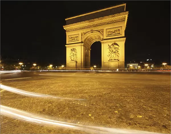 Traffic Light Trails Around The Arc De Triomphe; Paris France