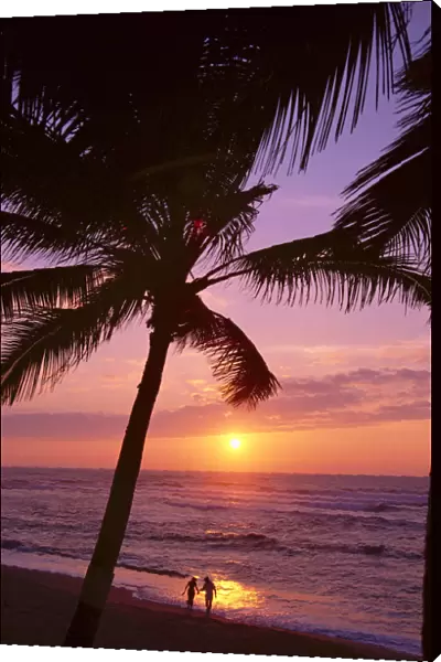 Couple In Distance On Beach Shoreline At Sunset, Palms, Silhouetted, Purple Orange Sky