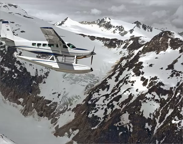 Cessna Caravan Amphibian Seaplane Flying Through The Coast Mountains; British Columbia Canada