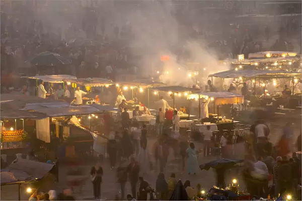 Morocco, People and food stalls in Place Djemaa el Fna at dusk; Marrakesh