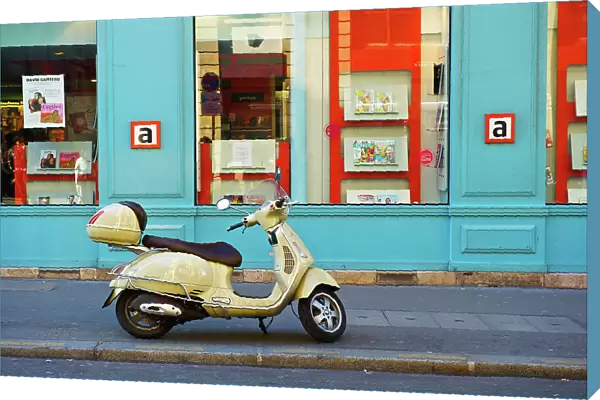 A Motorized Scooter Parked Outside A Blue Building Along A Street, Canal Saint Martin; Paris, France
