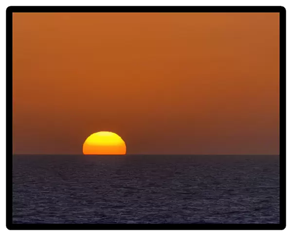 Sunrise with an orange sky over the North Sea, Netherlands