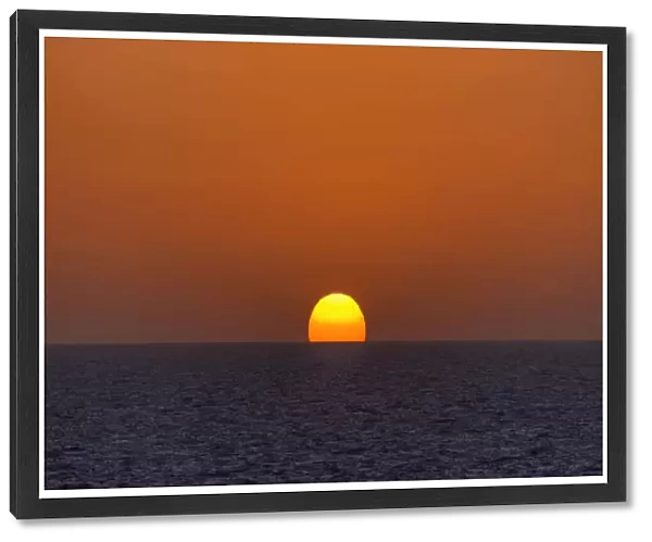 Sunrise with an orange sky over the North Sea, Netherlands
