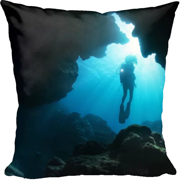 Diver exploring cavern, Yap, Micronesia