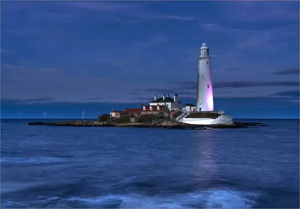 St Marys Lighthouse illuminated at night on Whitley Bay, Tyne and Wear, England, UK
