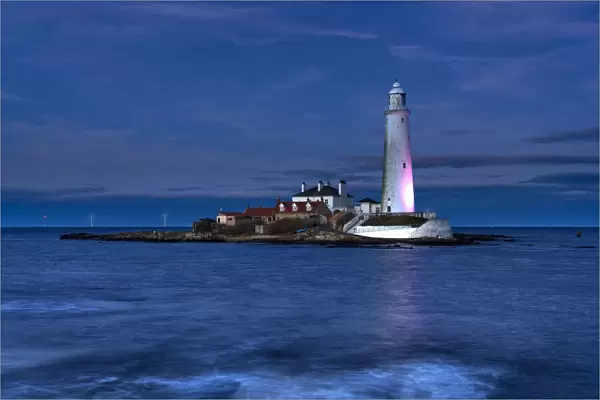 St Marys Lighthouse illuminated at night on Whitley Bay, Tyne and Wear, England, UK