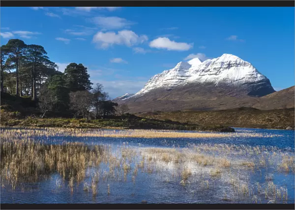 Looking across small lochen to Liathach covered in snow, Glen Torridon; Scotland, United Kingdom