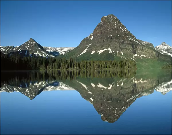 Sinopah Mountain reflects in Two Medicine Lake, southeastern part of Glacier National Park