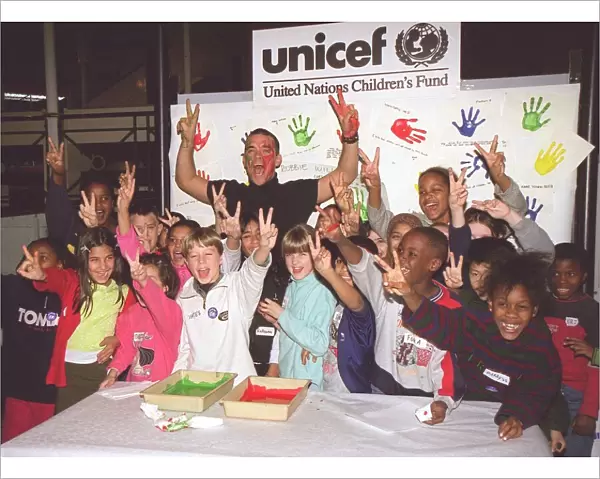 Singer Robbie Williams gets his hands dirty. November 1999. For Unicef