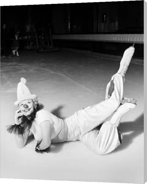 An Ice Skating female Clown performing, lying down. January 1953 D597-008