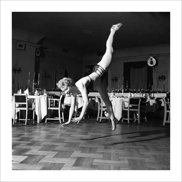 An Ice Skating Clown performing above parquet flooring. January 1953 D597-005