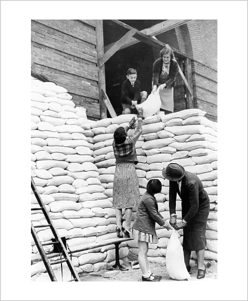 Women during WW2 - 1939 Parents and children help to sandbag the main entrance to