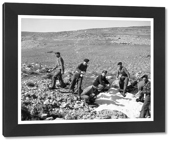 British soldiers on the way back from Wadi Pouse stop for a snowfall fight in Jordan