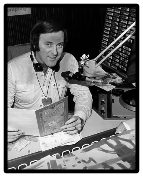 BBC Radio broadcaster Terry Wogan reading a Valentines card at his desk at the BBC