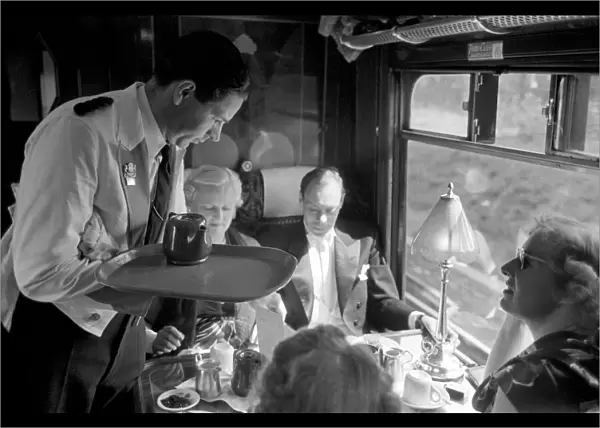 Opera goers express to Glynbourne British Rail waiter serves tea in the Buffet car