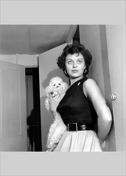 Actress Miss Elizabeth Webb with her poodle whose name is Skoshi. October 1953 D6060