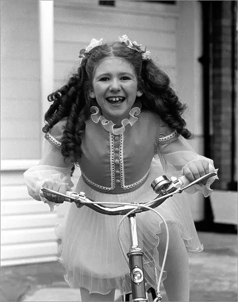 Child star Bonnie Langford at home on bicycle 1975