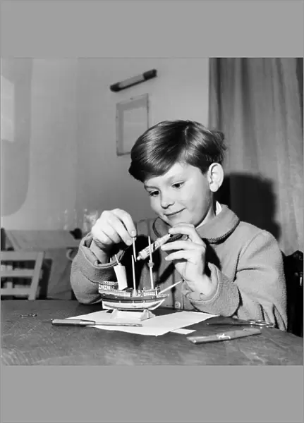 Young boy making a model replica of the HMS Victory, the ship of Lord Horatio Nelson