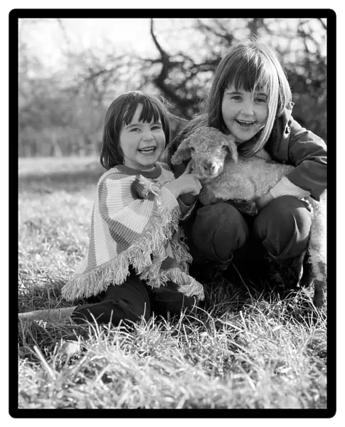 Young girls with spring lambs in Kent. January 1975 75-00492-002