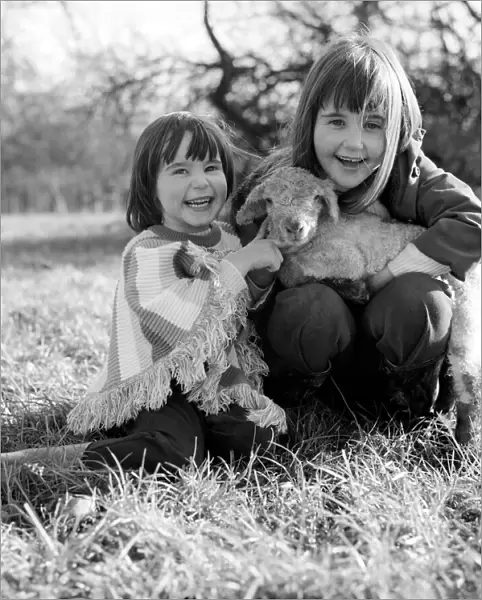 Young girls with spring lambs in Kent. January 1975 75-00492-002