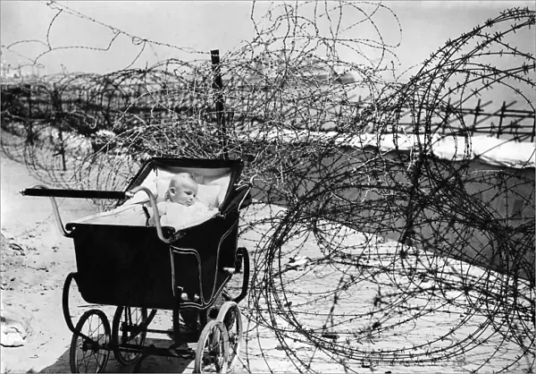 World War II: Home front. Baby enjoys the sea air as best she can at