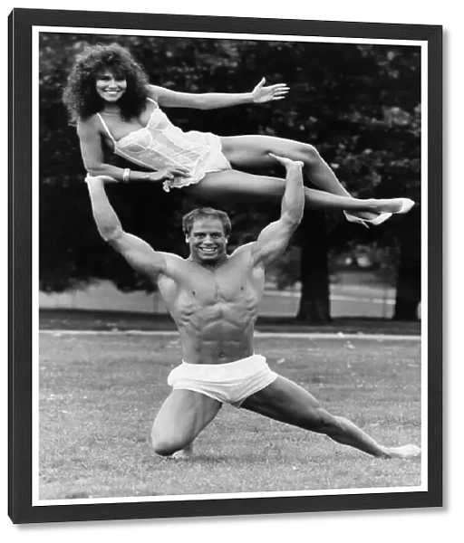 Model Linda Lusardi being lifted by nearly naked muscley strong man Julien Moss in