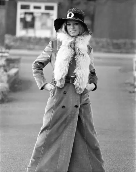 Woman wearing long maxi coat and hat. October 1969 Z10470-002