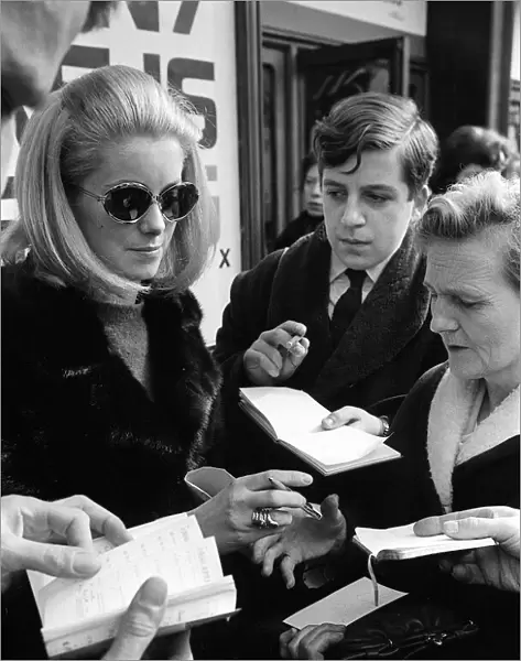 Catherine Deneuve march 1966 Signs autograph while leaving the theatre after