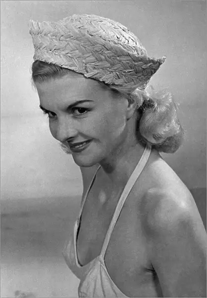 Woman wearing a bikini top and hat April 1953 P017644